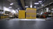Packages move along a conveyor belt in John F. Kennedy International Airport's mail room, en route to being inspected by CBP officers.