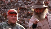 Buck and Trapper discussing the trap with the team.