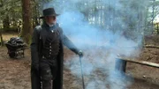 Noah Brown standing next to a fire.