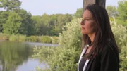 Aphrodite Jones reflecting near the water.