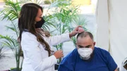 Dr. Lee examines Michael Steen during his consultation regarding a head cyst.