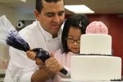 Buddy and Leah finishing the cake.