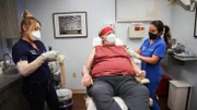 Dr. Lee takes samples of the skin lesions on Bob.