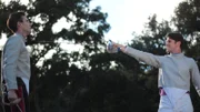 The wife's sons practice their swordsmanship with each other.