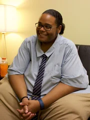 Brandon sits in chair at therapy session