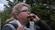 Mary blows a deer call while hunting. (National Geographic)