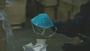 CBP Officer holding up a counterfeit N95 mask.
