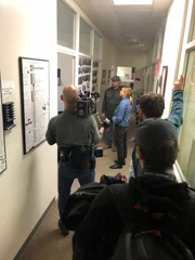 Oakland, CA - Mariana van Zeller with Oakland PD, discussing "wall of shame". (Credit: National Geographic)
