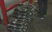 Large stack of packages suspected to be narcotics.