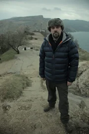 Tony Pollard standing in the foreground, with the Gun Battery in the background overlooking Bacalava Bay.