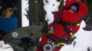 Shelby Fanning on a stretcher being pulled into the helicopter.