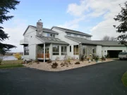 The front exterior of the Shoreview Estate with the lake in the background, as seen onMy Lottery Dream Home. (front exterior)