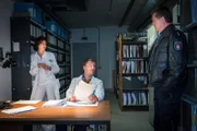 Dr. Lindberg (Hardy Krüger Jr., M.) und Jasmin (Gerit Kling, l.) zeigen Hans (Bruno F. Apitz, r.), was sie im Archiv des EKH gefunden haben. Nun wissen sie, was Gero Broog gesucht hat.