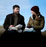 l-r: Cormoran Strike (Tom Burke), Robin Ellacott (Holliday Grainger)