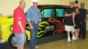 Brett, Robbie, Heather and Wayde  and Irwin stand in front of the car tank.