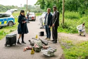 Rechtsmedizinerin Dr. Pilar Westphal (Yulia Yáńez Schmidt, l.) und die Kommissare Matti Wagner (Pierre Besson, M.) und Jonas Fischer (Lukas Piloty, r.) spekulieren, wie der tote Angler Uwe Ratke ums Leben kam – Unfall oder Mord? (Komparsen im Bild)