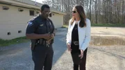 Aphrodite speaks with Lt. Gwinn outside of the laundromat.