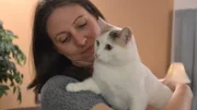 Angela holding Kali in her home.
