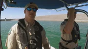 Wardens McGinley and McColl on their boat.