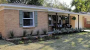 Landscaping frames the front porch.
