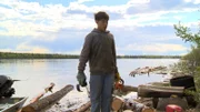 Francis Roberts helps his father cut driftwood.