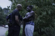 A detective talks with a suspect.