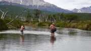 Cody Lundin and Dave Canterbury crossing a river.