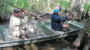 Dave Canterbury and Cody Lundin paddling down river in Louisiana.