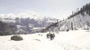 Rock Raiders walk in the snow of the Himalayas.