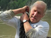 Stan Zuray works to lower his fishwheel into the river.