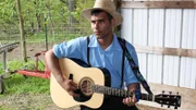 Matt playing guitar in his barn.