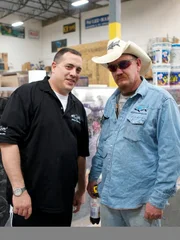 Wayde King CEO of Acrylic Tank Manufacturing, left, and Robert Chrislieb standing in front of the newly build casino tank in the warehouse.