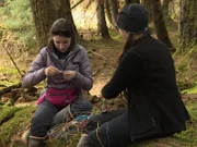 Rain Brown and Bird Brown making things out of wiring for electronics in the woods.