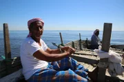 Fishermen collect pearls