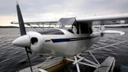 A seaplane on the water with pontoons.