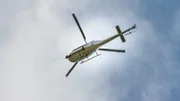 Tv Helicopter flight in blue sky.