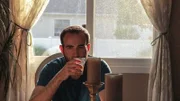 Michael with a drink in his hand.