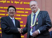 Der stellvertretende kambodschanische Premierminister Sok An (L) schüttelt dem britischen Khmer-Kunstsammler Douglas Latchford (R) während einer Veranstaltung im Nationalmuseum von Kambodscha in Phnom Penh die Hand.