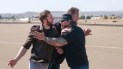 Danny Thompson holds back the competition while Ken Cage gets the airplane ready to fly.