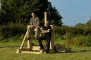 L-R: Monty Hall and Stuart Prior sitting on Trebuchet.