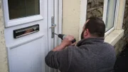 The man opens the lock with the drill