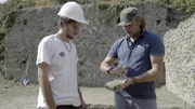 Der Archäologiestudent Dario Lo Surdo (L) und der Archäologe Mario Grimaldi von der Universität "Università degli Studi Suor Orsola Benincasa" untersuchen einen Ochsenschädel, der unter einer Straße in Pompeji gefunden wurde.