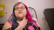Medium Close Up of Kim Heeks, touching her neck, displaying her Hirsutism