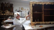 Ein Mann, der an einem Holzstück arbeitet.