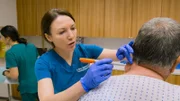 Dr Emma marking the area of Bill’s Lipoma in Clinic. Bill sitting on clinic bed, facing away from camera. Nurse Rosie in background...No..