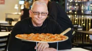 Chef Robert Irvine reviews the food from the old menu at Deraney's Two City Tavern; as seen on Food Network's Restaurant: Impossible Season 18.