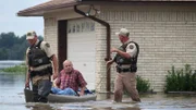 Chris and Benny rescue a man from his flooded home.