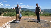 David Bromstad poses with the winners outside one of the homes on HGTV's My Lottery Dream Home