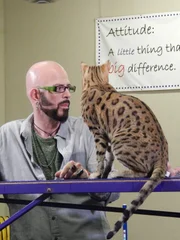 Jackson Galaxy next to Zeus who's sitting on a rail.