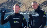 Camera operator Andy, and safety diver Nick pose for a picture before going in Bullet Cage.
